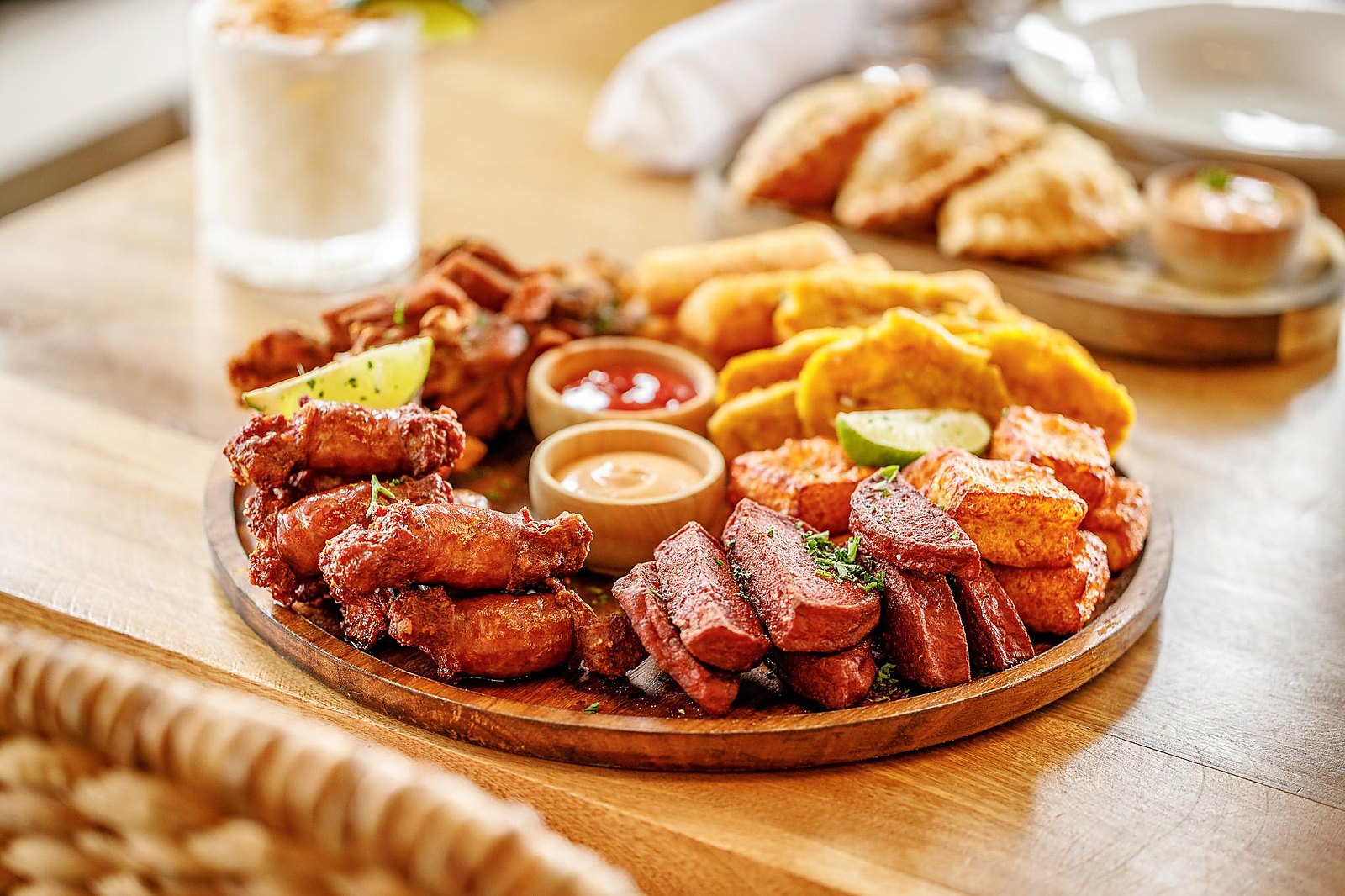 Picadera platter with fried cheese, salami, chicharrón and tostones